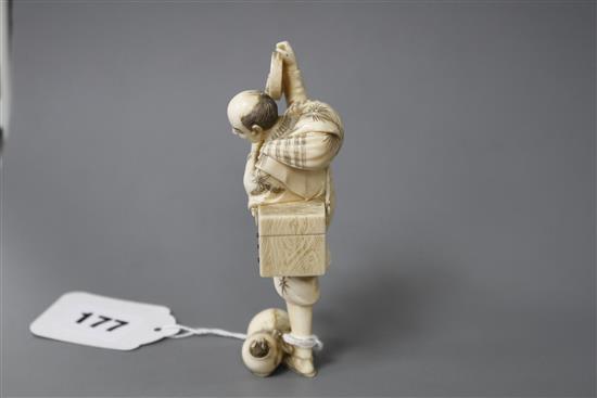 A Japanese carved ivory figure of an entertainer startled by a rat, late Meiji period, signed, height 11.5cm